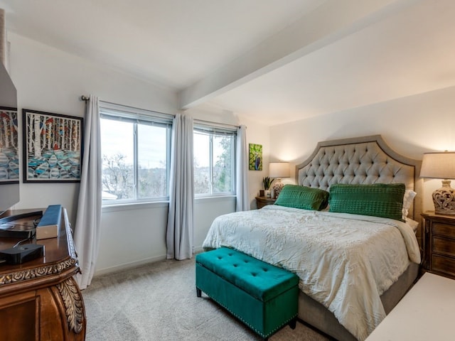 carpeted bedroom featuring beamed ceiling