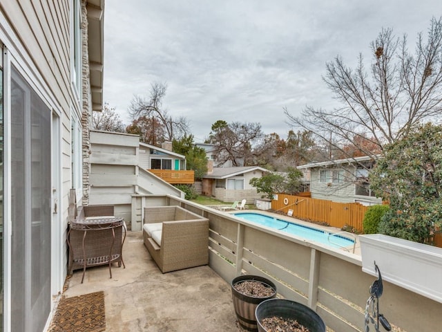 view of patio / terrace with a fenced in pool