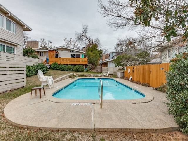 view of swimming pool with a wooden deck and a patio area