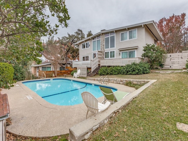 view of pool featuring a yard and a deck