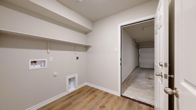 clothes washing area with gas dryer hookup, hookup for a washing machine, light hardwood / wood-style flooring, and hookup for an electric dryer