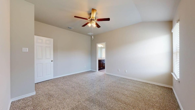 carpeted empty room featuring vaulted ceiling and ceiling fan