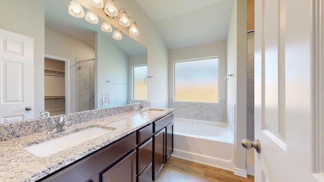 bathroom with vanity, hardwood / wood-style floors, and a tub