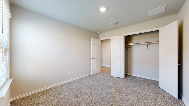 unfurnished bedroom featuring a closet and carpet