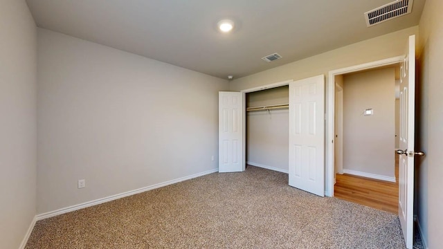 unfurnished bedroom with carpet floors and a closet