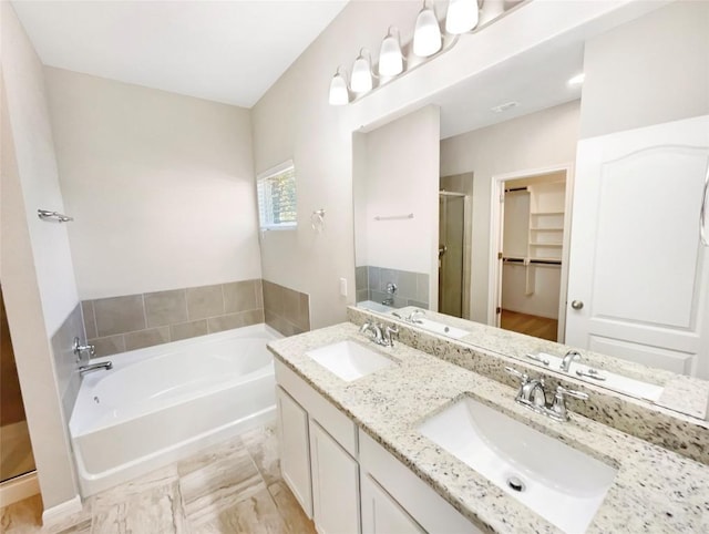 116 San View Dr, Georgetown, TX 78628 - full bathroom with a shower stall, a bath, double vanity, and a spacious closet