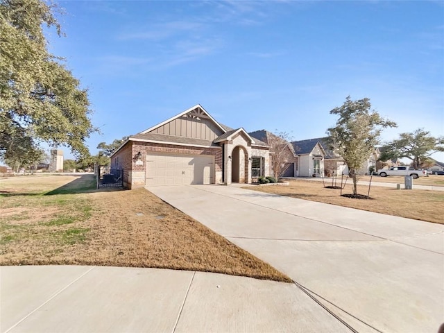 116 San View Dr, Georgetown, TX 78628 - view of front of house with brick siding, concrete driveway, a garage, a front yard, and board and batten siding