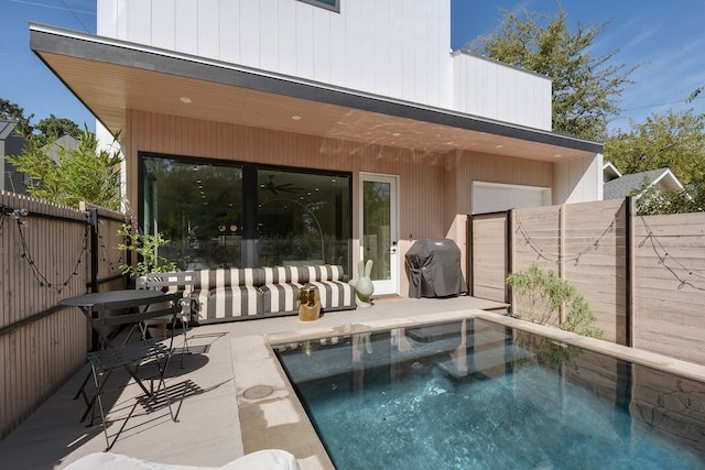 rear view of property featuring a fenced in pool and a patio area