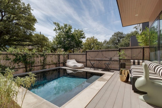 view of pool with a fenced backyard