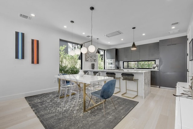 dining area featuring light wood-type flooring, visible vents, and recessed lighting