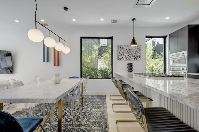 dining room with visible vents, a wealth of natural light, and recessed lighting