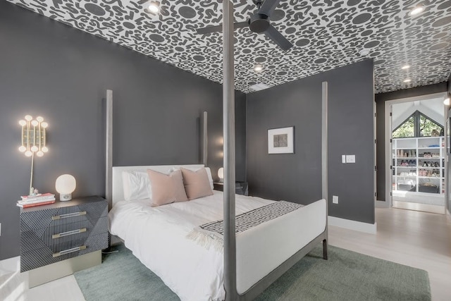 bedroom featuring baseboards and wood finished floors