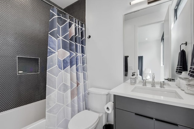 bathroom featuring shower / bathtub combination with curtain, vanity, and toilet