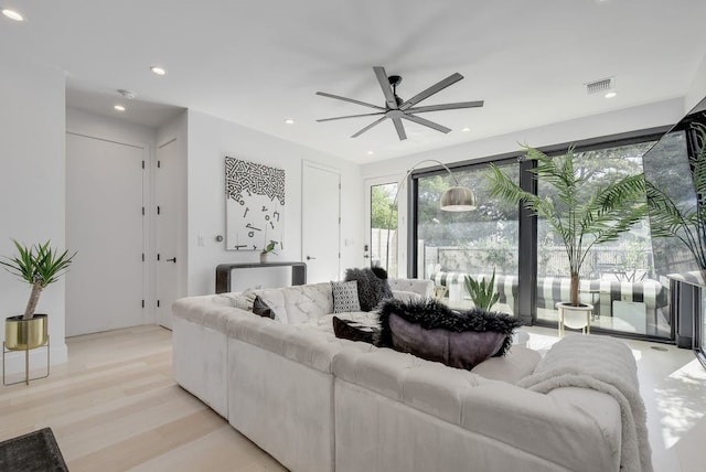 living area with light wood-style flooring, visible vents, a ceiling fan, and recessed lighting