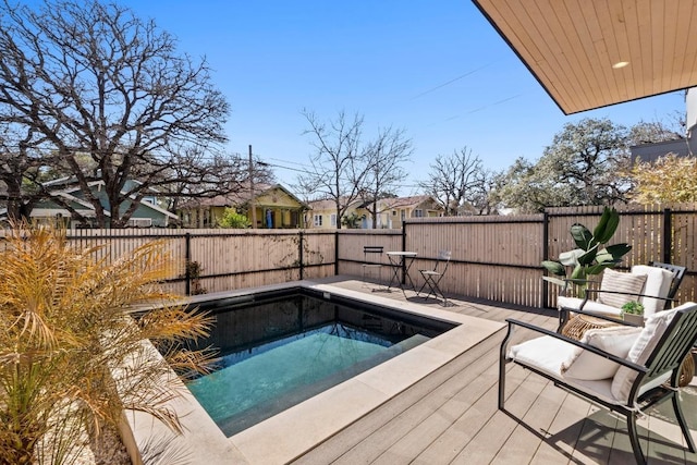 view of swimming pool with a fenced backyard