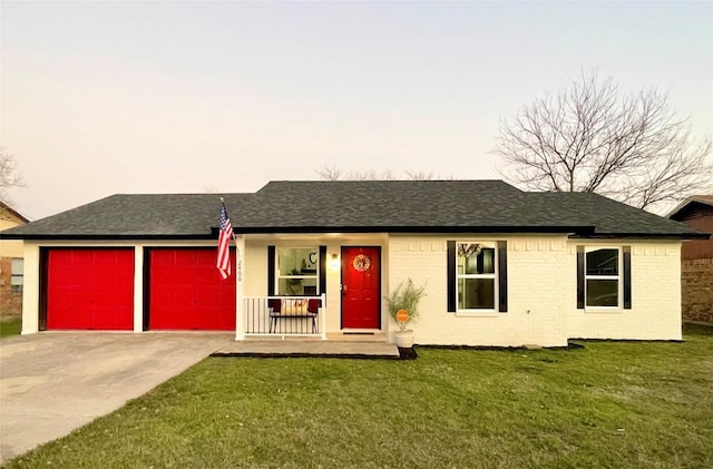 ranch-style house with a garage, a lawn, and covered porch