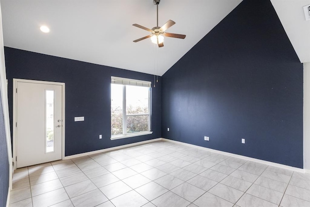 empty room featuring high vaulted ceiling, light tile patterned floors, and ceiling fan