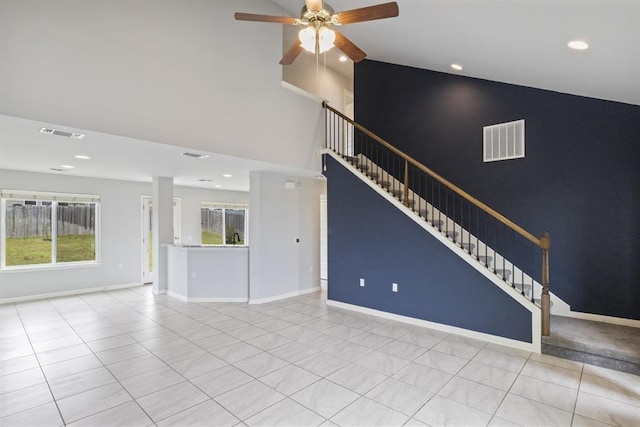 unfurnished living room featuring ceiling fan, high vaulted ceiling, and light tile patterned floors