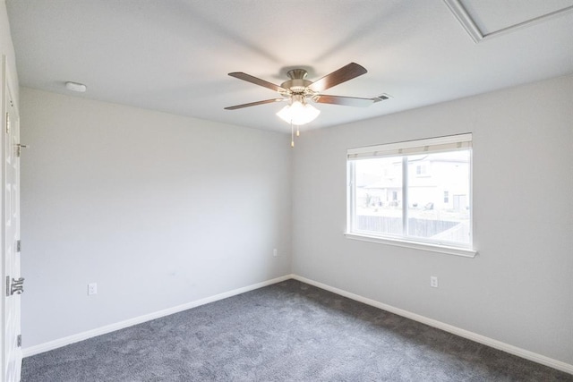 unfurnished room featuring ceiling fan and dark colored carpet