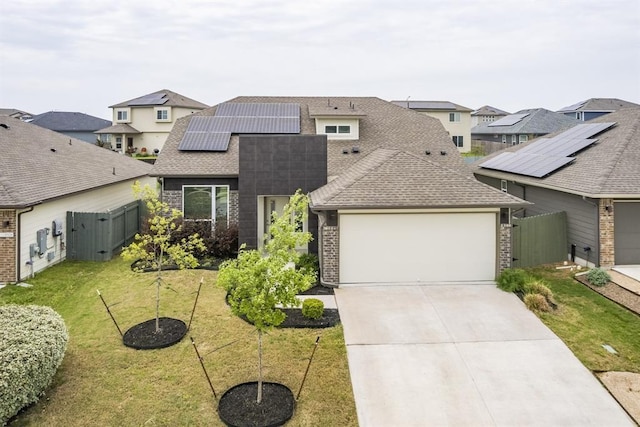 view of front of property with a front yard and solar panels