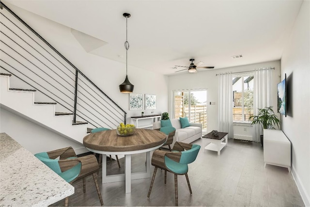 dining area featuring dark hardwood / wood-style flooring and ceiling fan