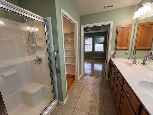 bathroom with vanity, tile patterned floors, and walk in shower