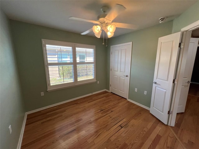 unfurnished bedroom featuring wood-type flooring and ceiling fan