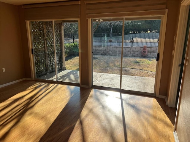 doorway to outside with wood-type flooring