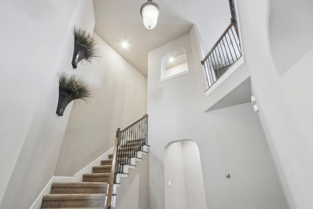 staircase with a high ceiling