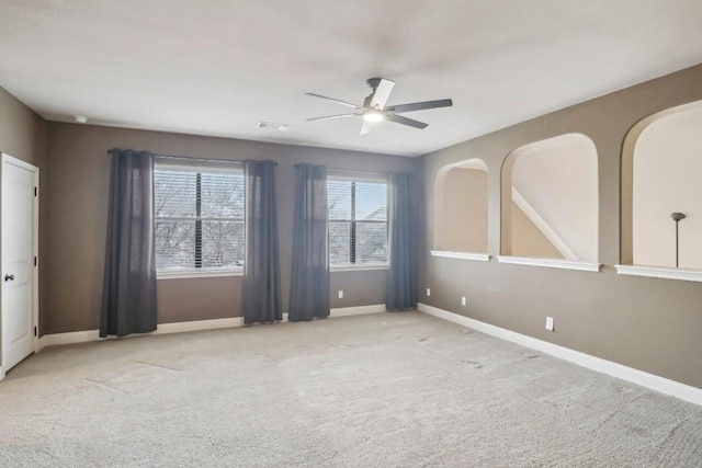 empty room with light colored carpet and ceiling fan