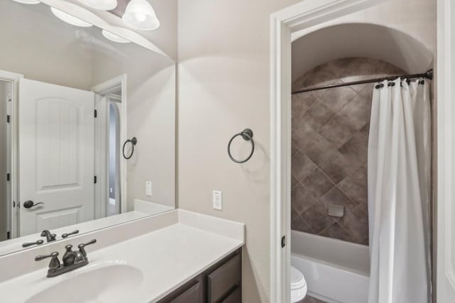 full bathroom with vanity, toilet, and shower / bath combo with shower curtain