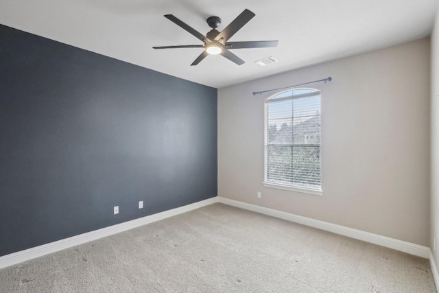 empty room with ceiling fan and carpet