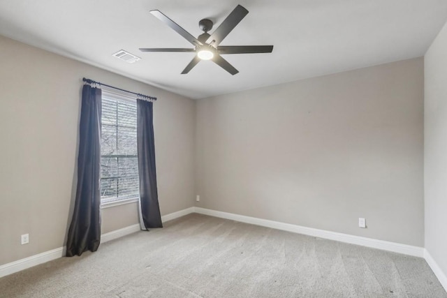 carpeted spare room featuring ceiling fan