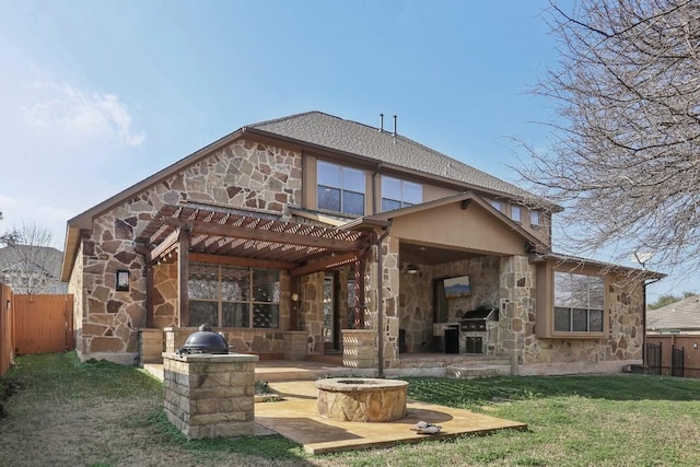 back of property featuring an outdoor fire pit, a yard, a fireplace, and a patio area