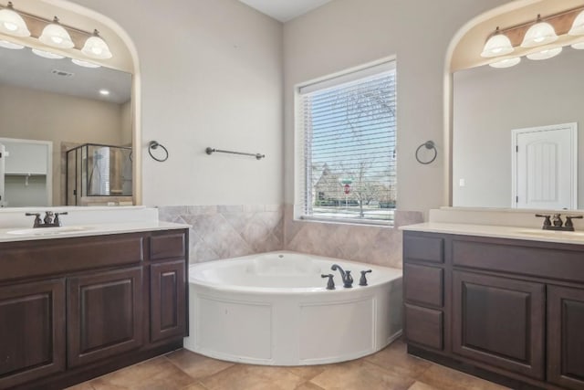 bathroom with tile patterned flooring, vanity, and independent shower and bath