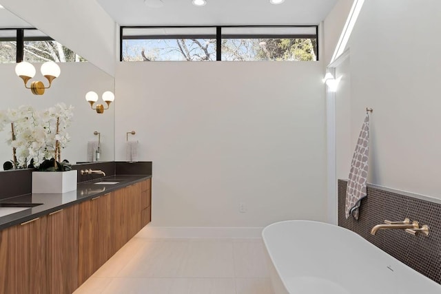 4502 Hyridge Dr, Austin, TX 78759 - full bathroom featuring double vanity, a freestanding bath, plenty of natural light, and tile patterned flooring