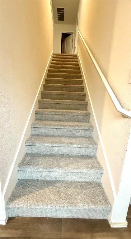 stairs featuring hardwood / wood-style flooring