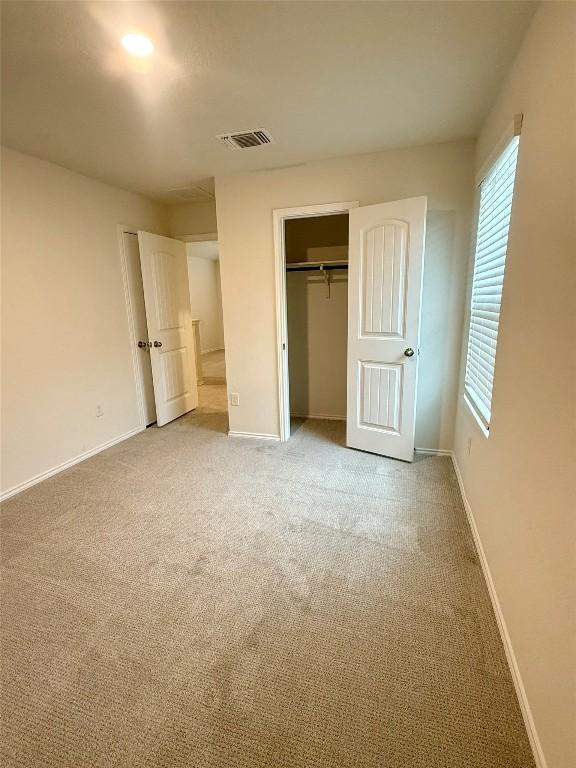 unfurnished bedroom with a closet and carpet