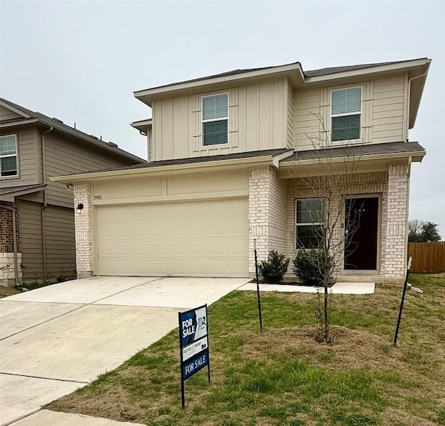 view of front of property with a garage and a front yard