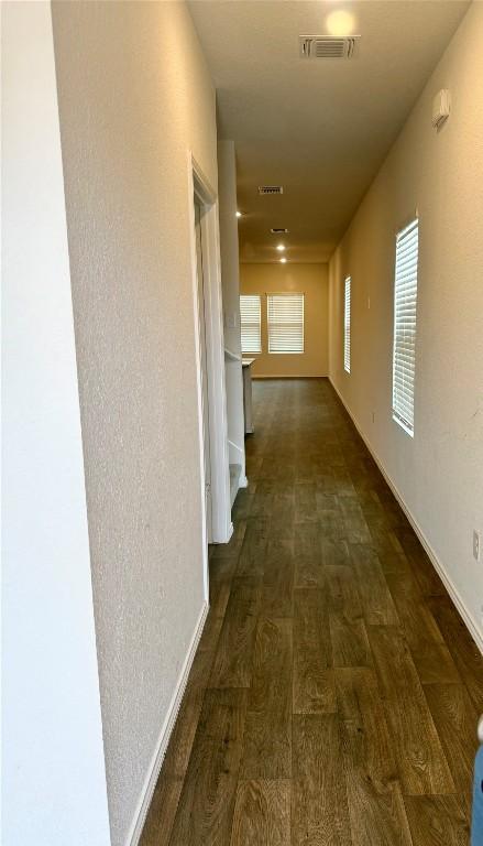 hallway featuring dark hardwood / wood-style flooring