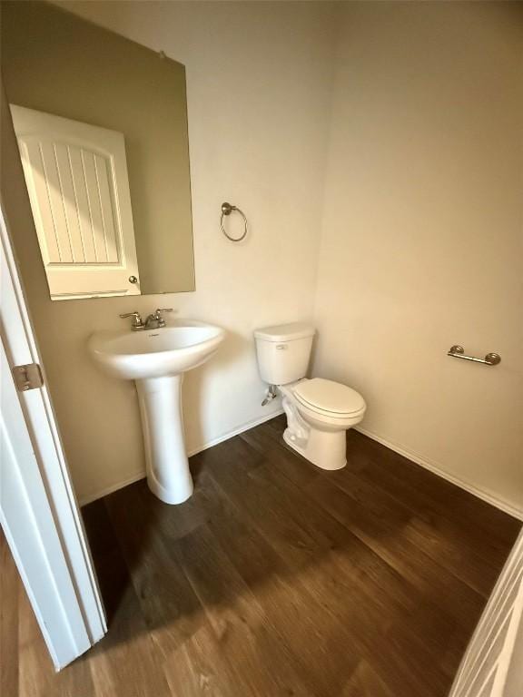 bathroom featuring wood-type flooring, sink, and toilet