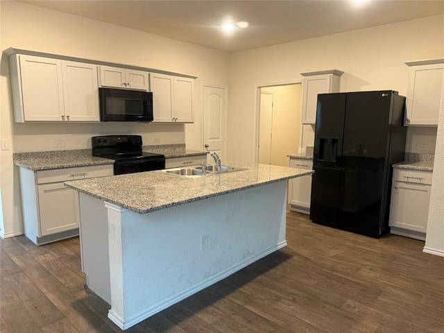 kitchen featuring white cabinetry, sink, a center island with sink, and black appliances