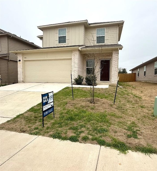 view of front of home with a garage and a front lawn