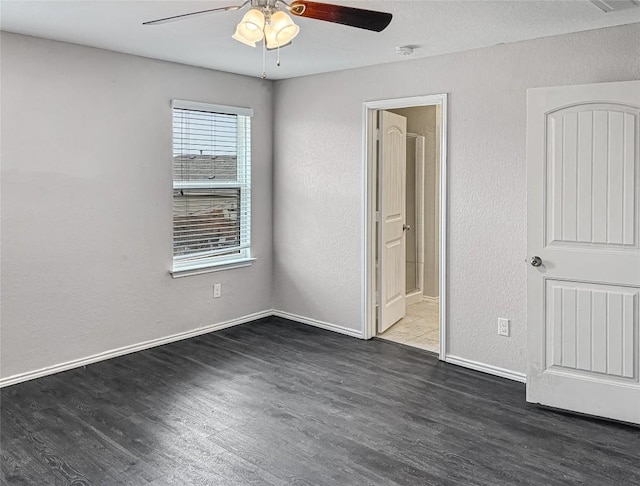 unfurnished room with ceiling fan and dark hardwood / wood-style flooring