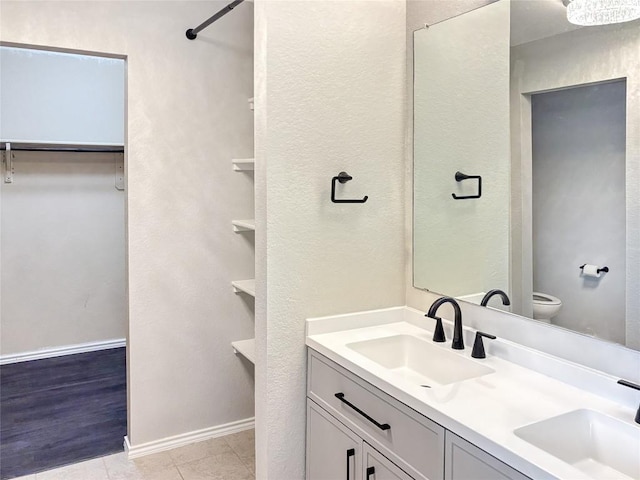 bathroom featuring vanity, toilet, and tile patterned flooring