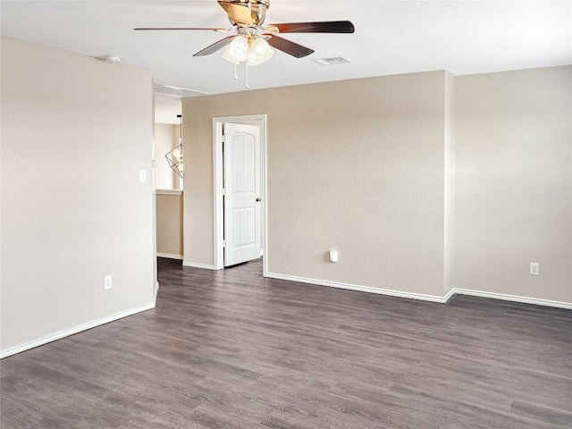 unfurnished room featuring dark wood-type flooring and ceiling fan