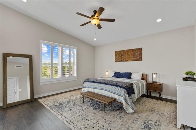 bedroom with ceiling fan, lofted ceiling, and hardwood / wood-style floors