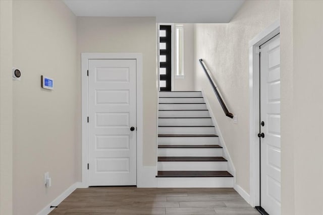 stairs with wood-type flooring