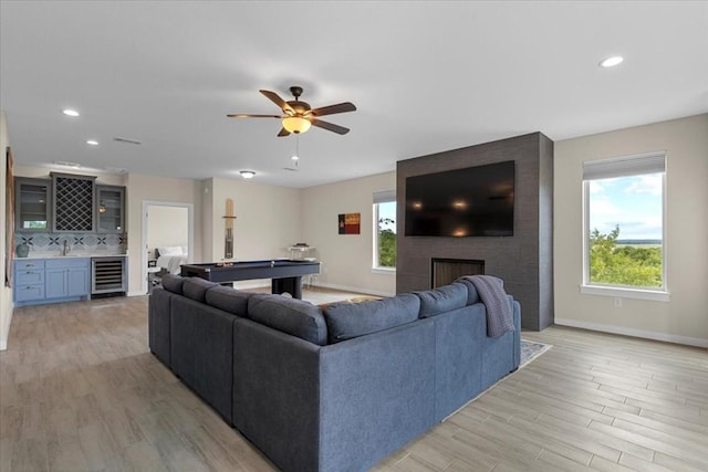 117 Nakalele Ln, Bastrop, TX 78602 - living area featuring wine cooler, a dry bar, light wood finished floors, baseboards, and recessed lighting