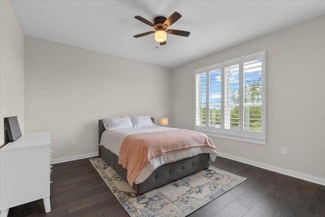 bedroom with ceiling fan and dark hardwood / wood-style flooring